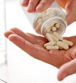 close-up-of-man-pouring-pills-from-jar-to-hand-PUGULFB.jpg